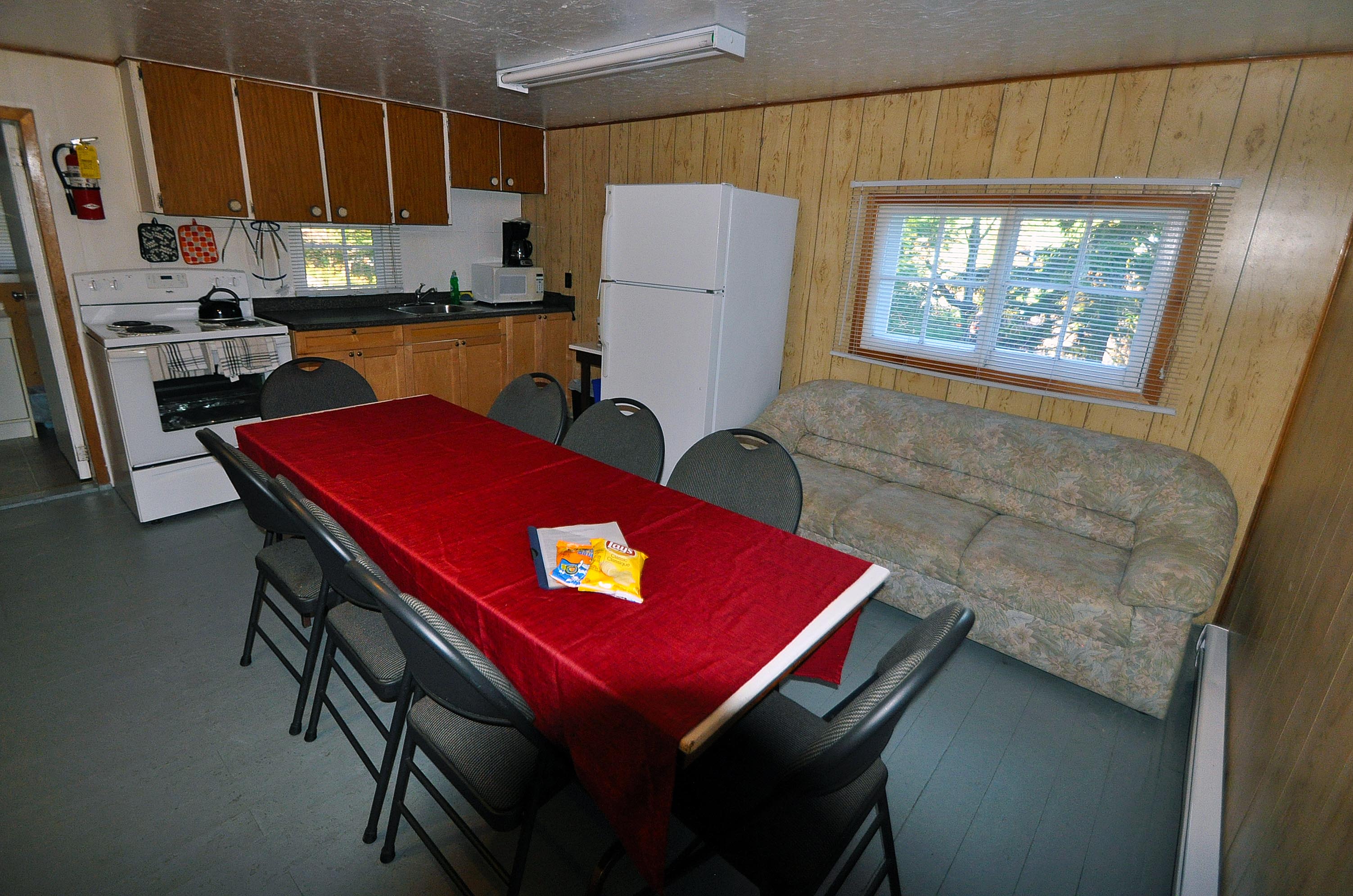 Cabin 16 kitchen, dining table and sofa.
