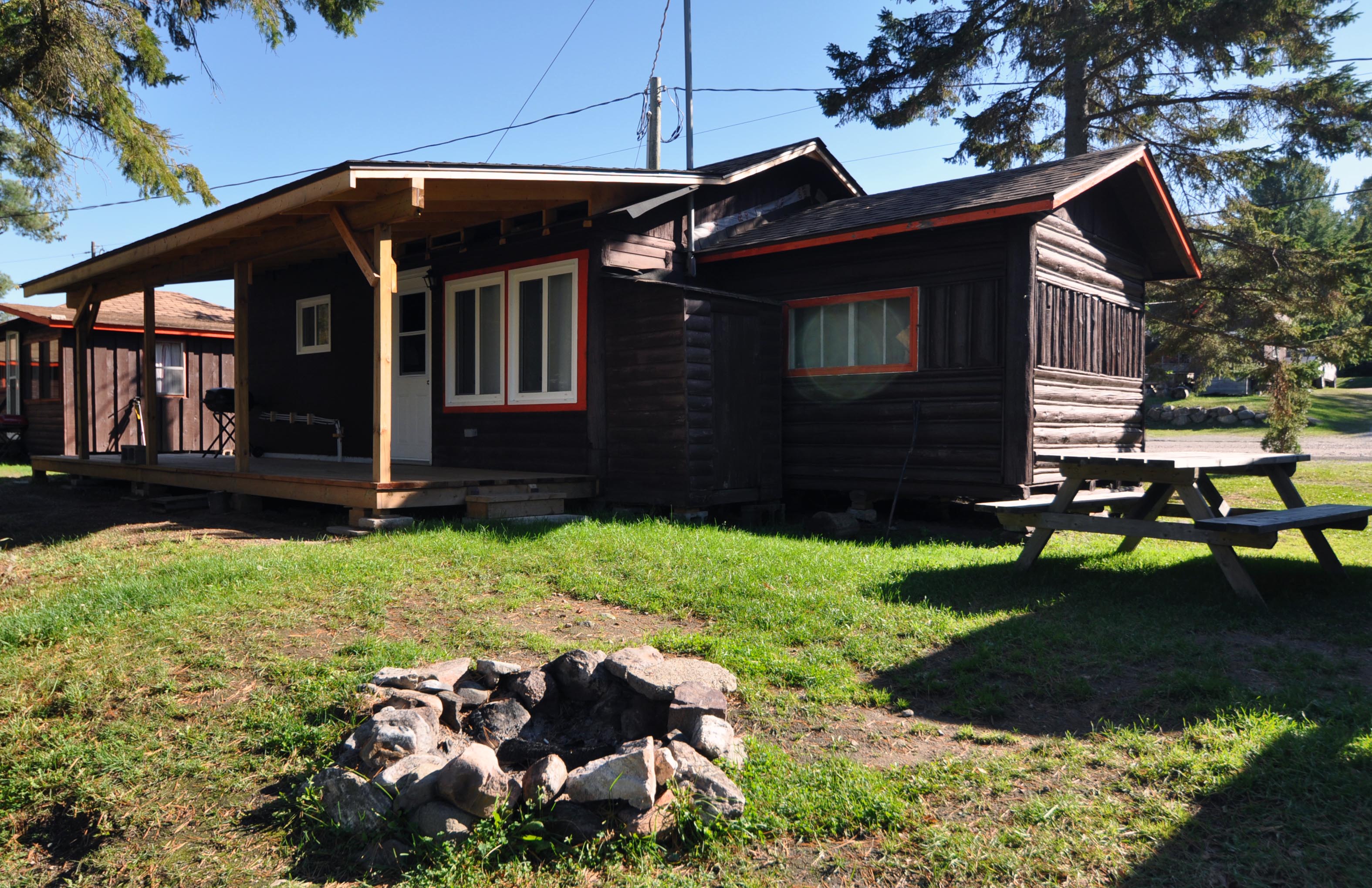 Cabin 5 - exterior with picnic table and fire pit.