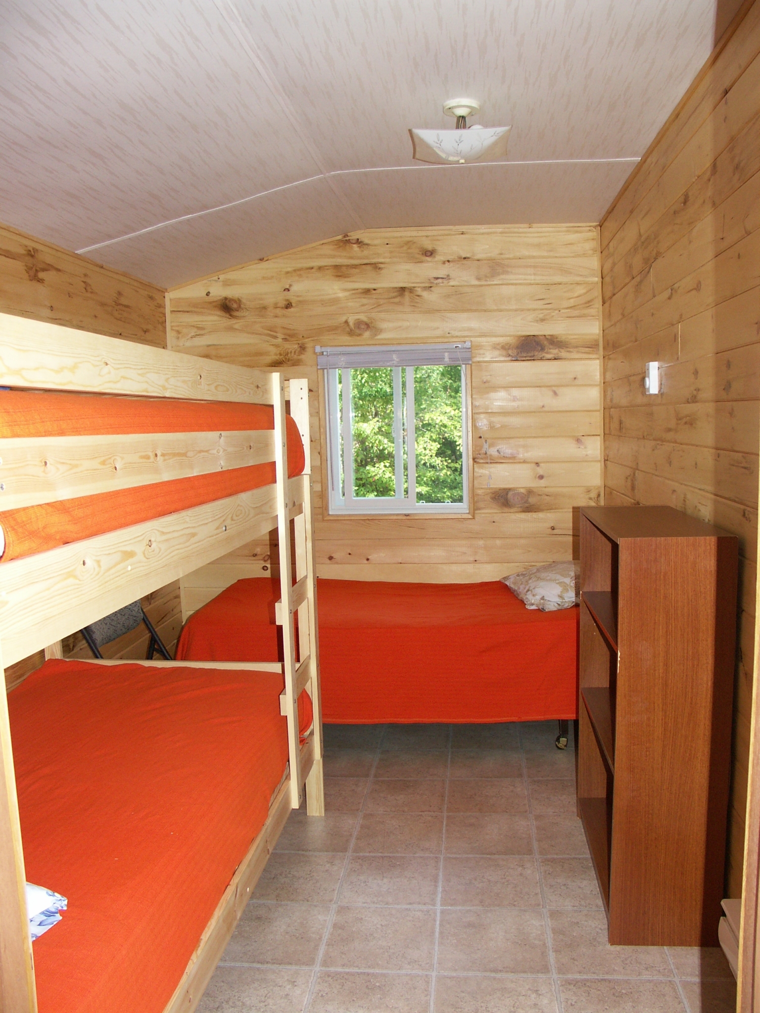 Cabin 8 - Bedroom with single bed and bunk bed.
