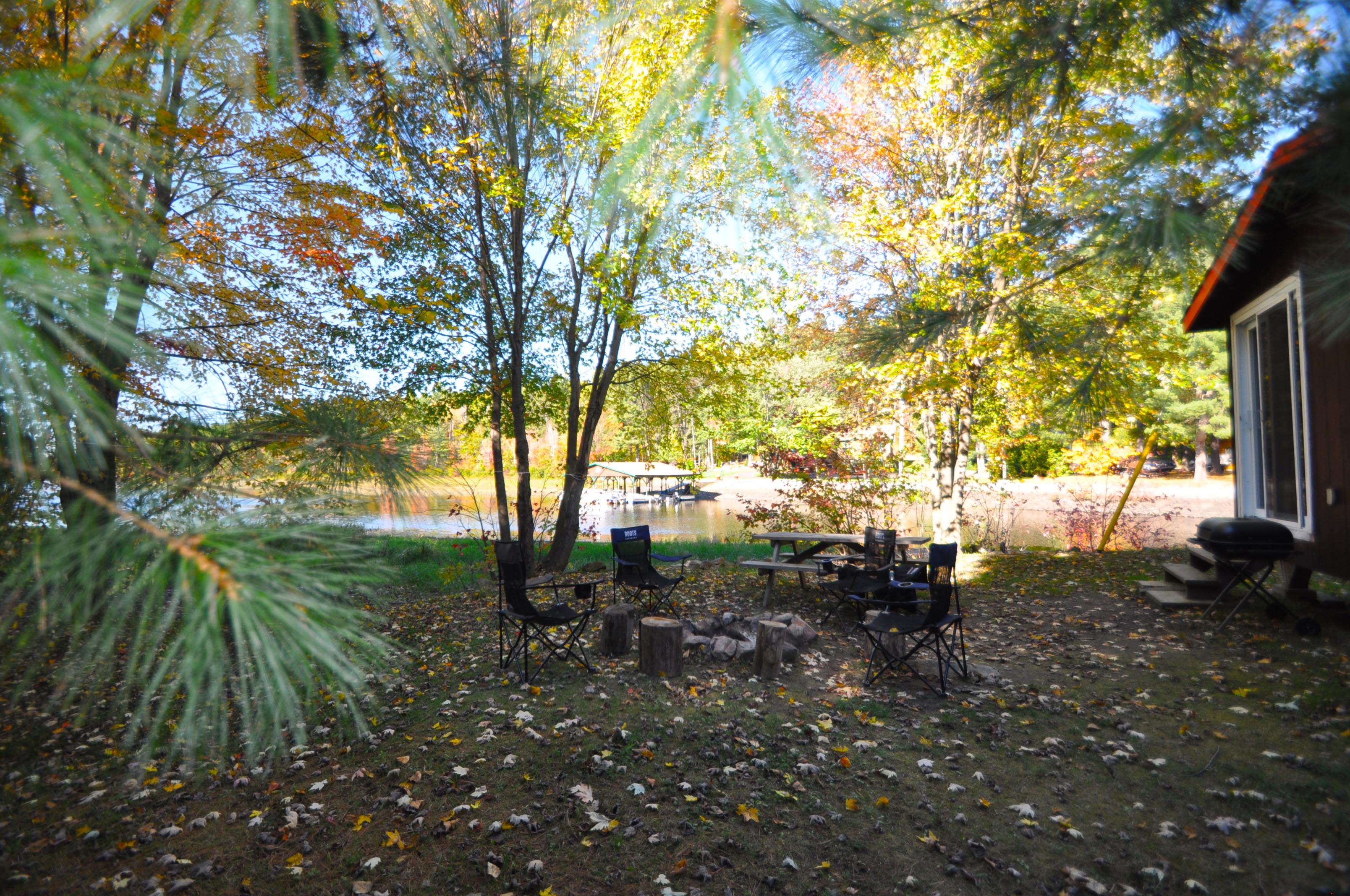 Cabin 8 - yard with picnic table, chairs and firepit.