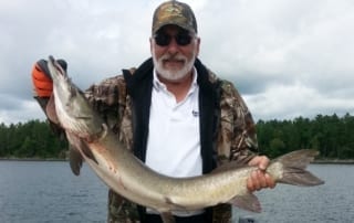 Monte holding a large muskie.