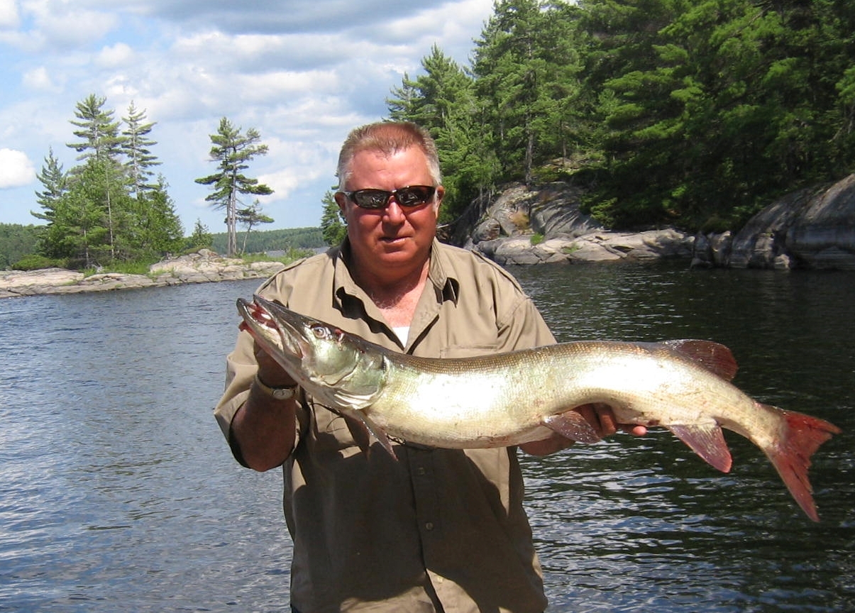 Percy holding 44 inch muskie.