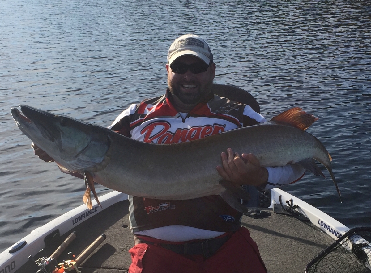 Mike holding 56 inch muskie.
